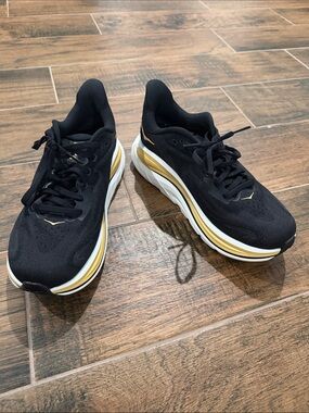 Hoka Women's Black Athletic Shoes with Gold and White Trim